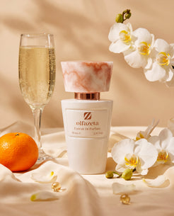 White bottle Olfazeta by Chogan Millésime N°67 with a champagne flute, mandarin and white orchids