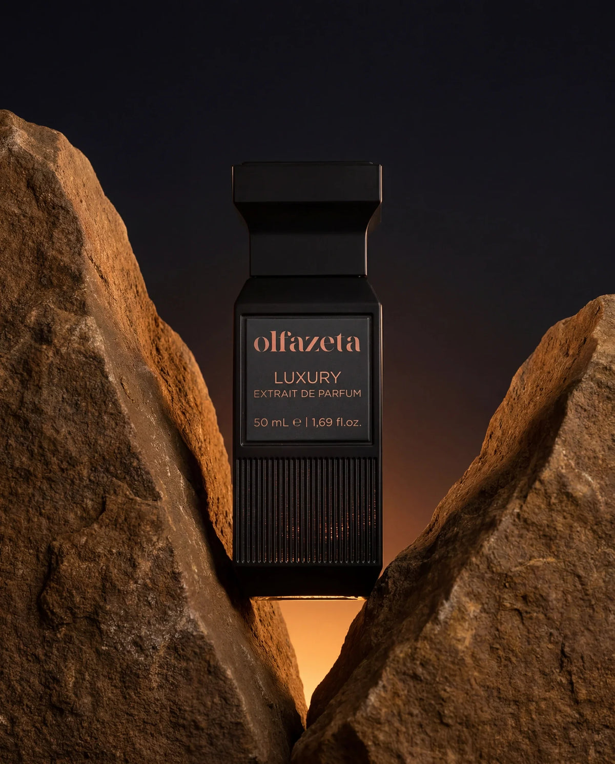 Black Olfazeta by Chogan Luxury N°74 bottle standing between two ochre rocks at sunset